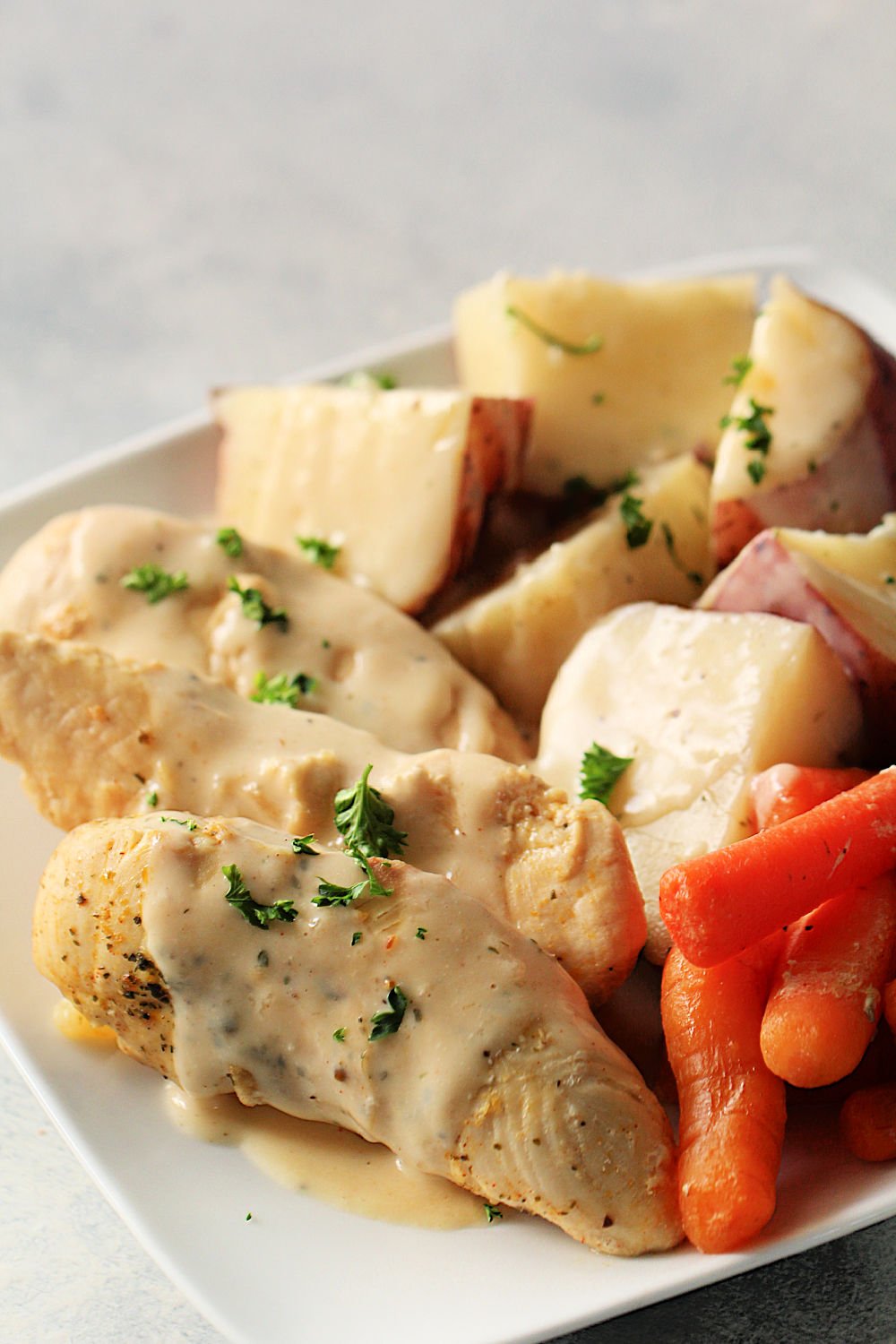 Instant Pot Creamy Ranch Chicken with Potatoes and Carrots on a serving dish