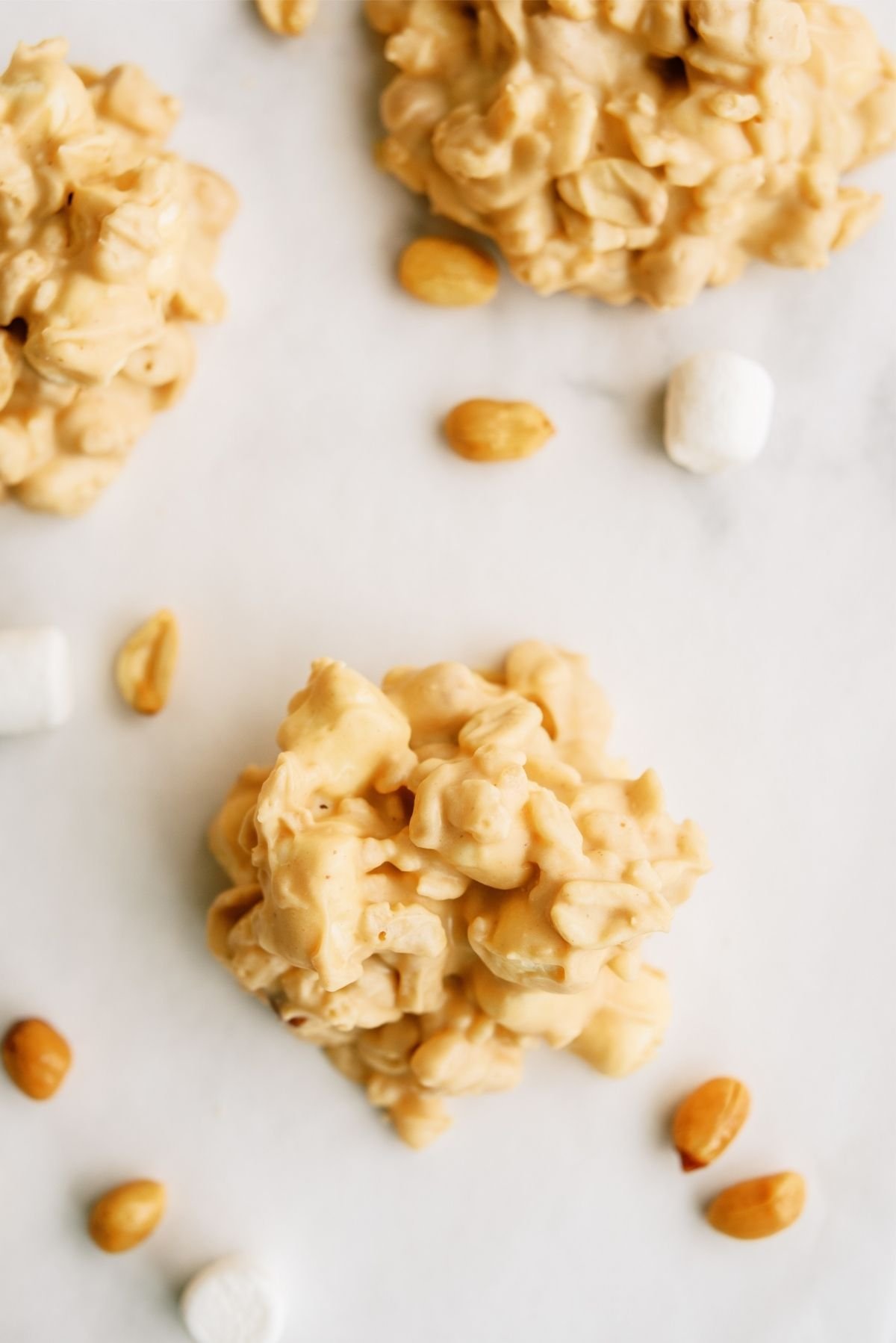 Easy No Bake Fluffernutter Cookies on a counter with peanuts and marshmallows