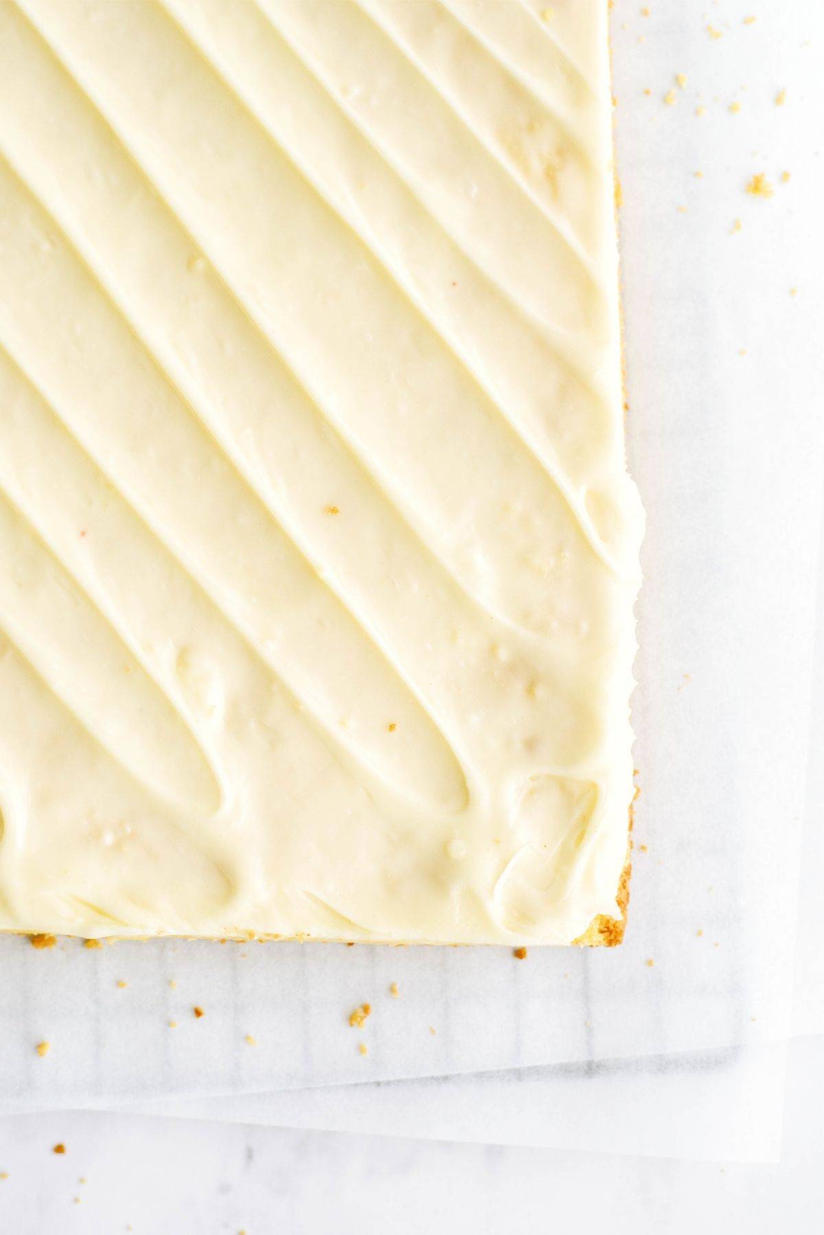 Frosted Gooey Lemon Bars on a cooling rack