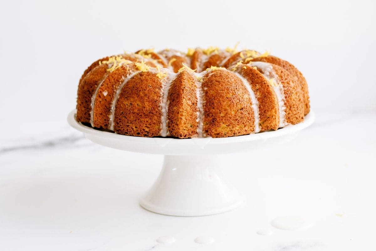 Lemon Poppy Seed Bundt Cake on a cake stand.