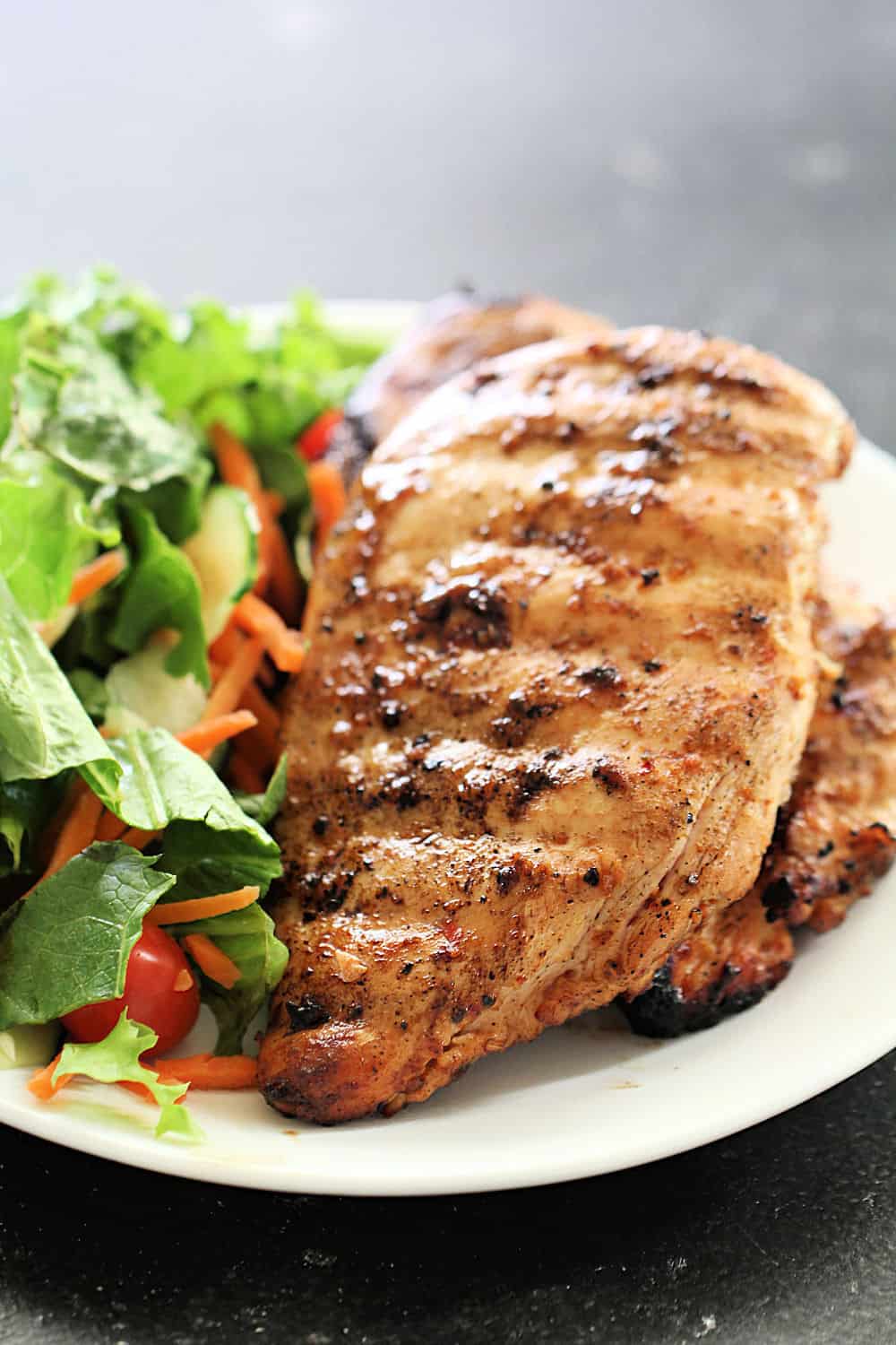 Easy smoked chicken breast on a plate with salad