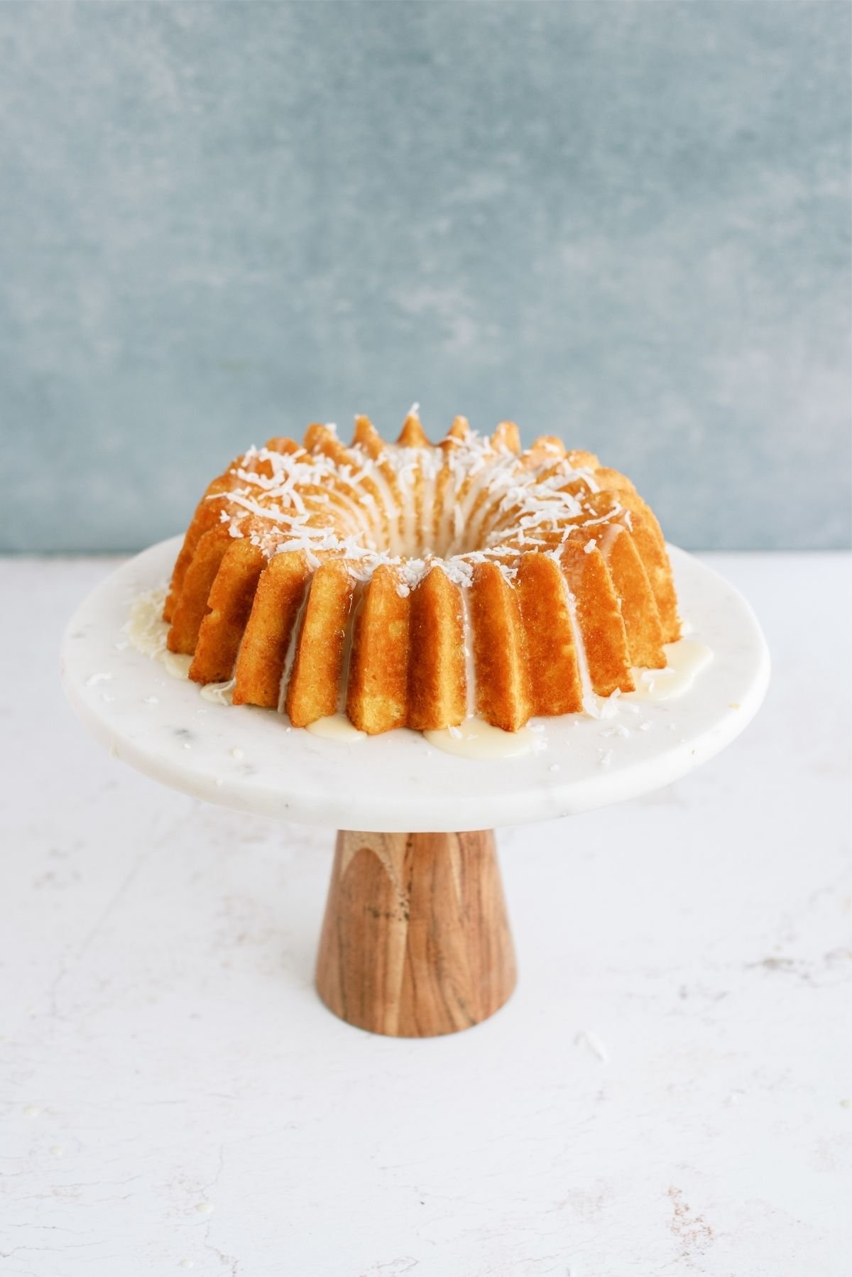 Pineapple Coconut Bundt Cake on a cake stand