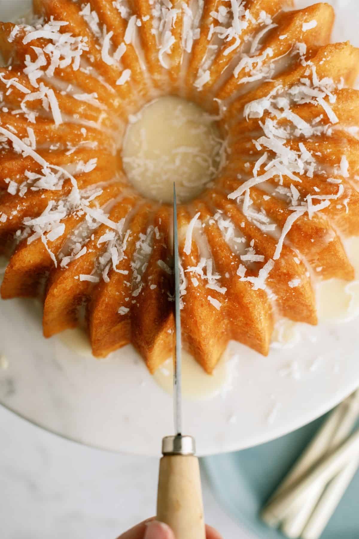 Slicing Pineapple Coconut Bundt Cake