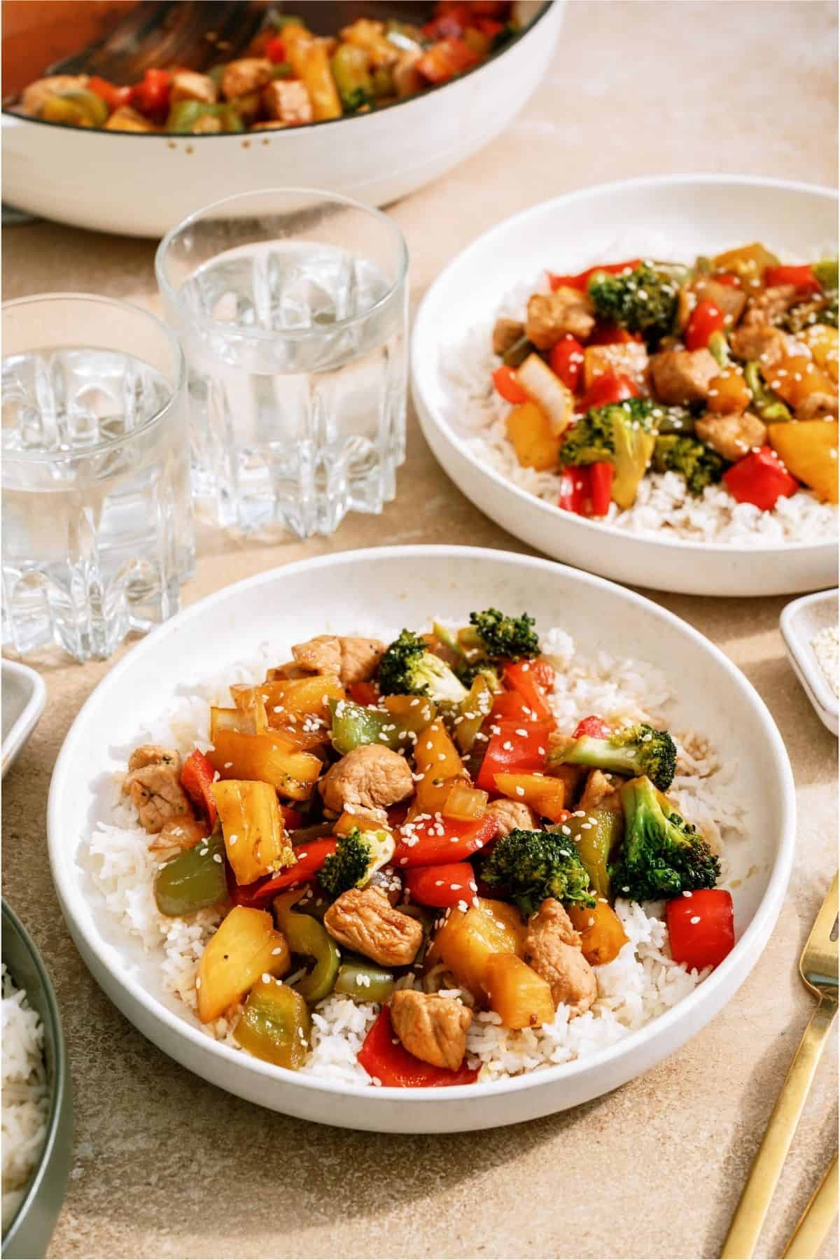Two plates that have Teriyaki Pork Stir Fry served over rice.