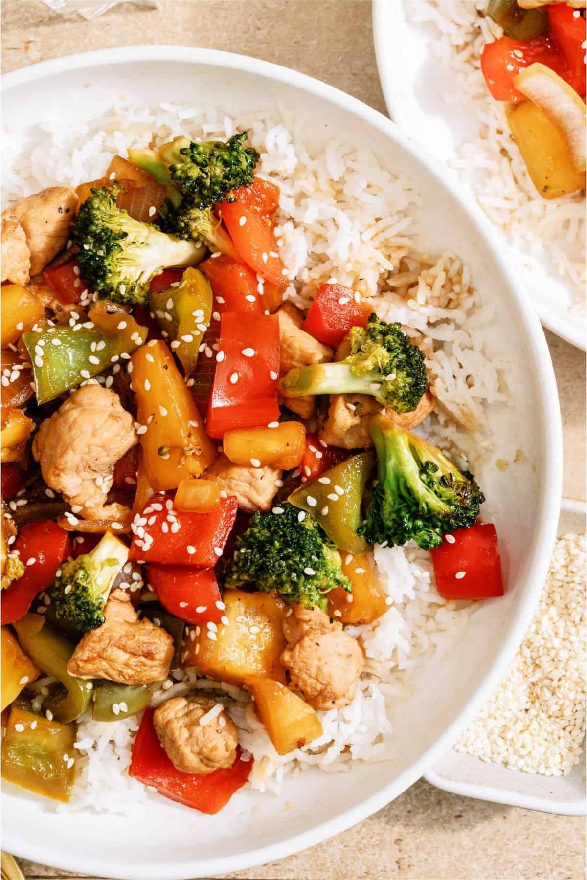 Top view of a bowl of Teriyaki Pork Stir Fry served over rice.