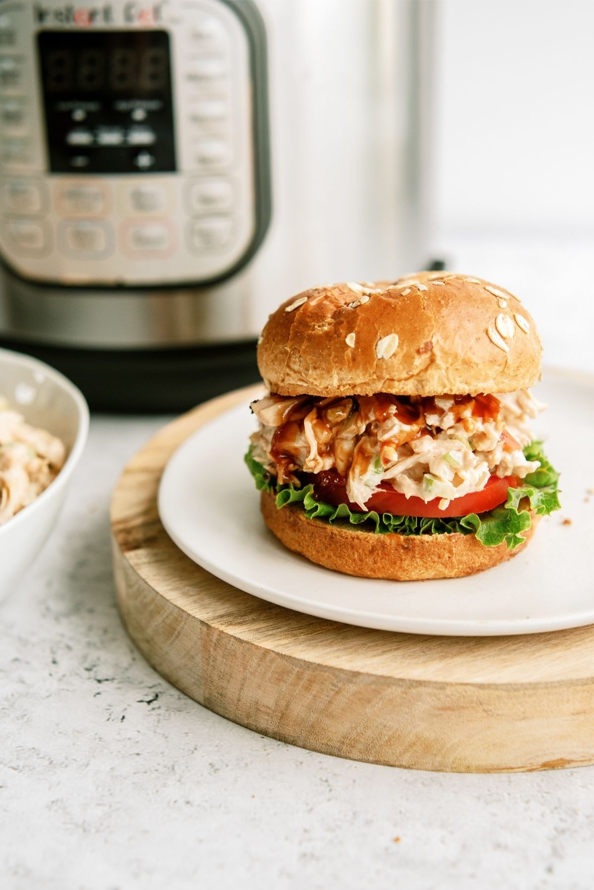 BBQ Chicken Salad Sandwich on a plate with an Instant Pot in the background