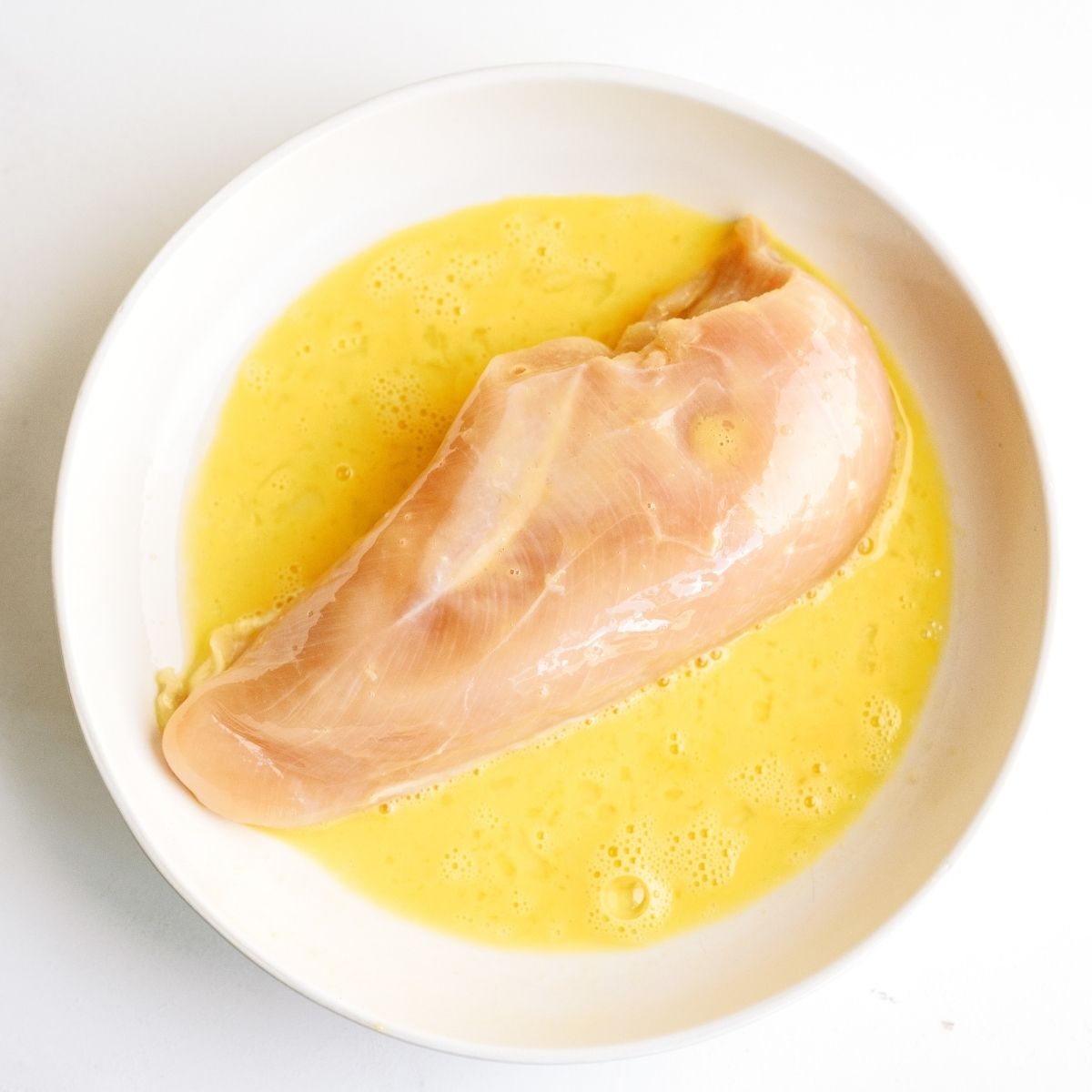 Raw chicken dipped in egg