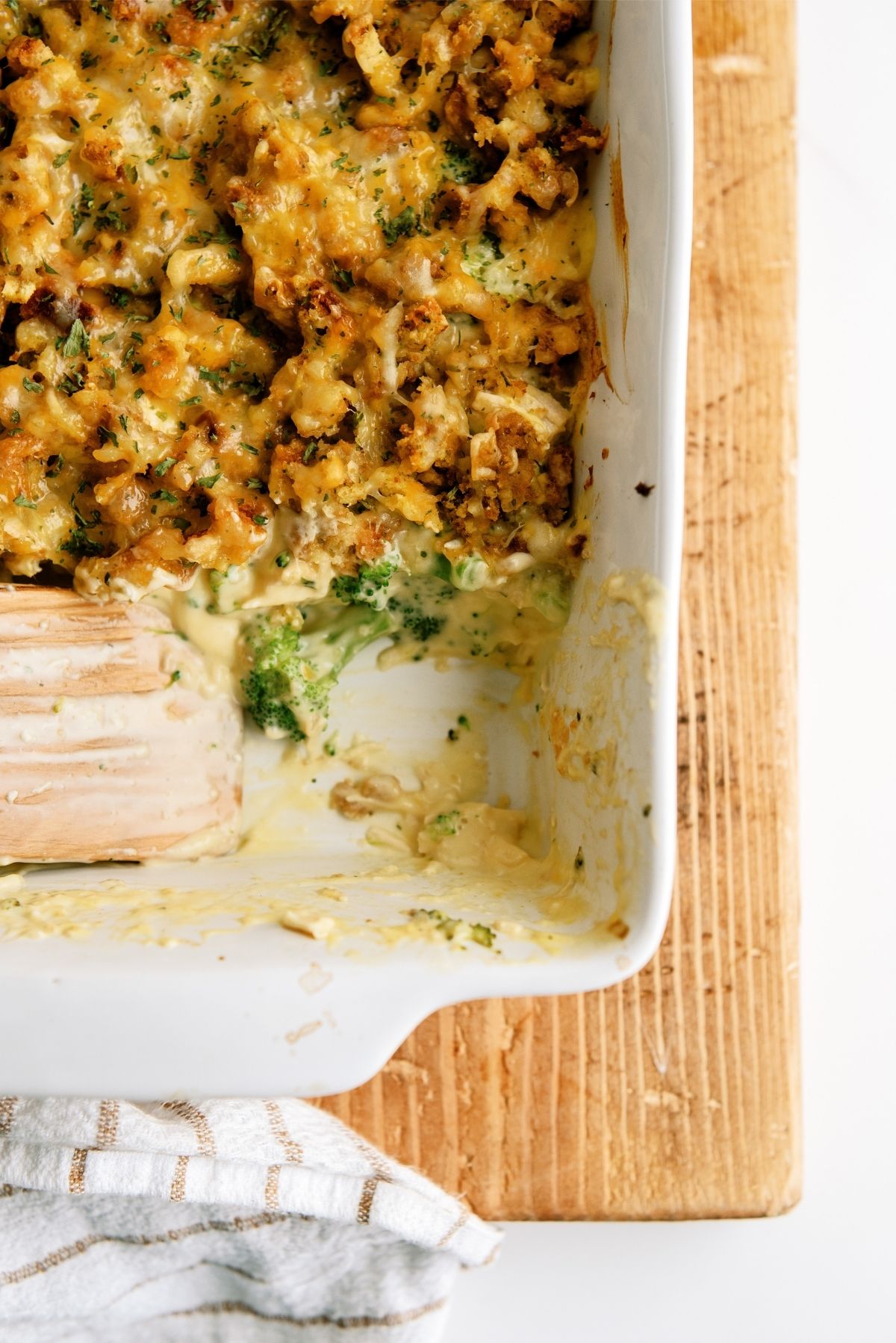 Chicken and Broccoli Stuffing Casserole in a casserole dish missing a serving