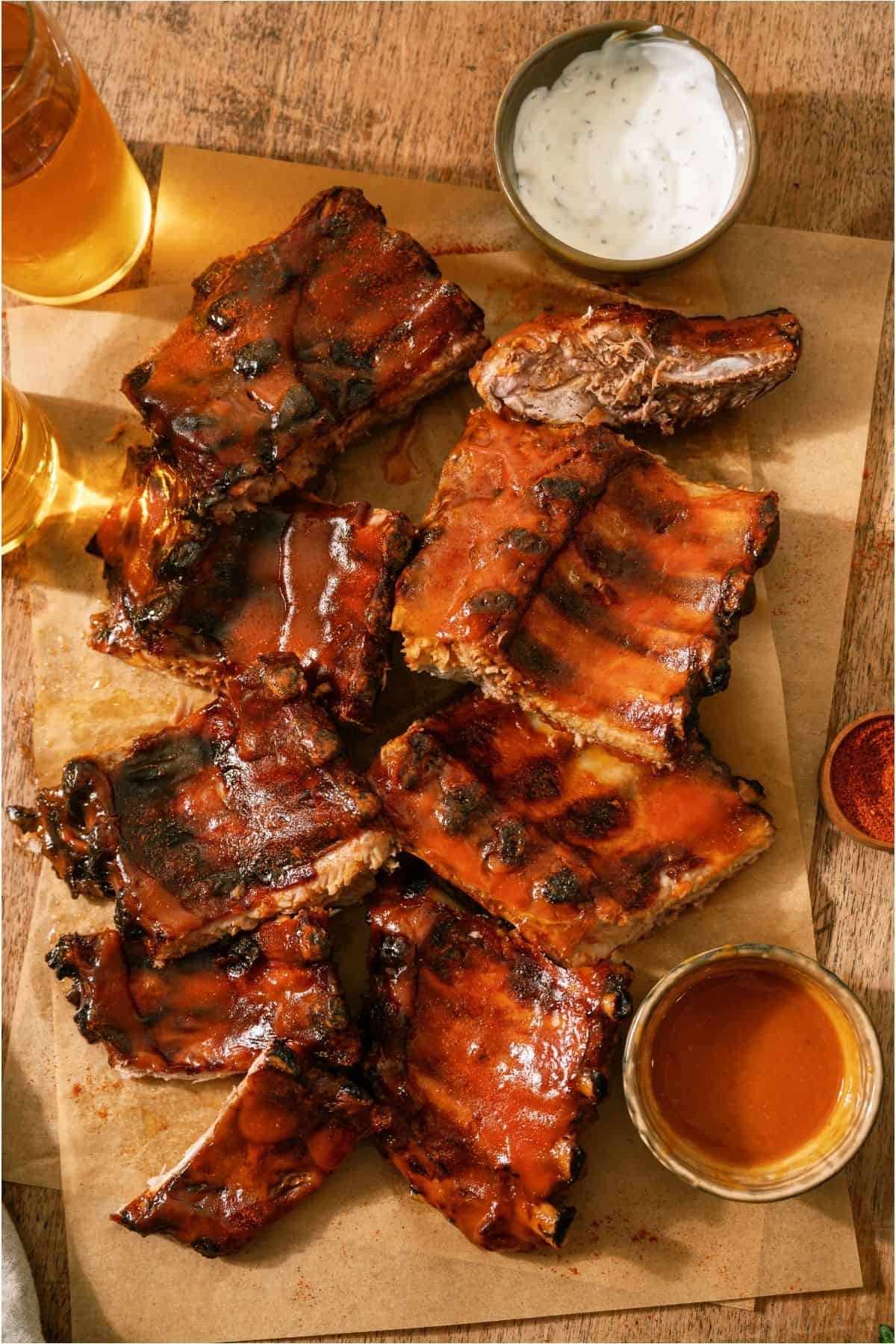 Easy Smoked BBQ Ribs on parchment paper with dipping sauce.