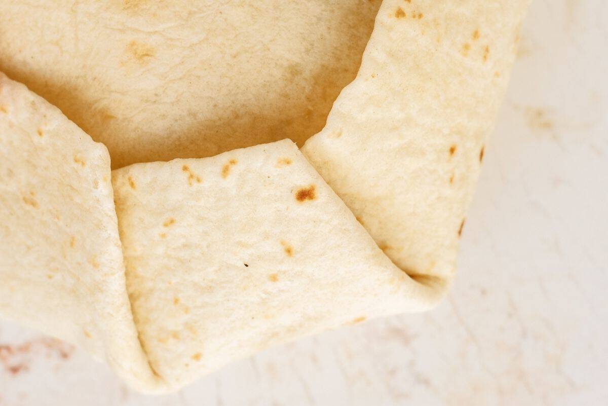 Large tortilla folded around the smaller tortilla stack