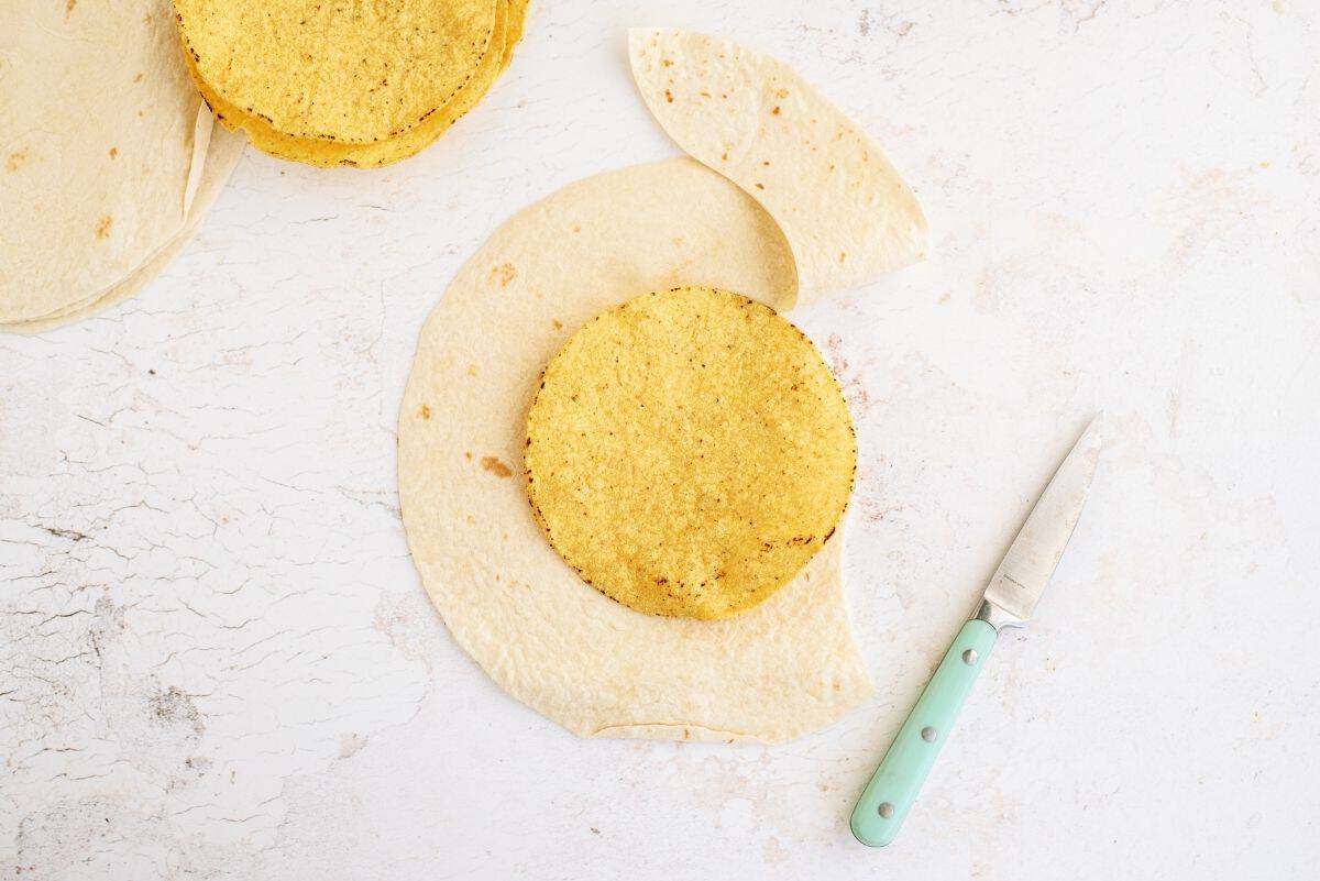 tostada in the center of tortilla shell to use as a stencil