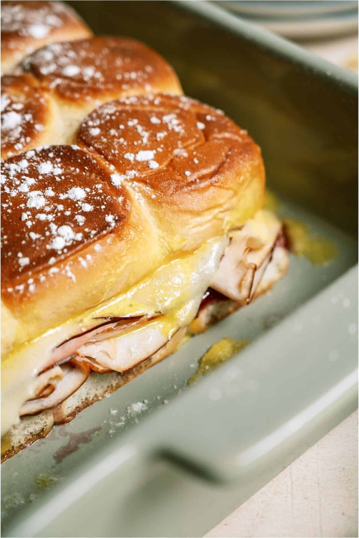 Close up of Monte Cristo Slider Sandwiches in the pan.