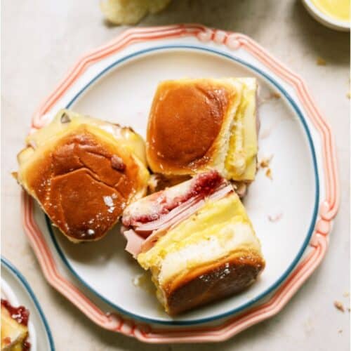 A plate with 3 Monte Cristo Slider Sandwiches with one turned on it's side.