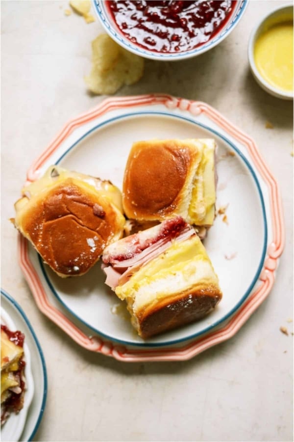 A plate with 3 Monte Cristo Slider Sandwiches with one turned on it's side.