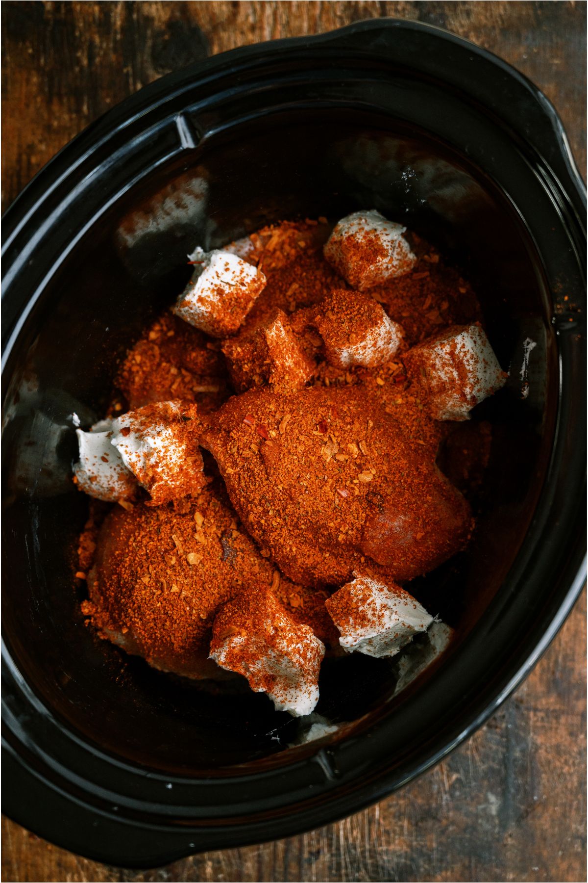 Chicken, seasoning and cream cheese in the slow cooker/