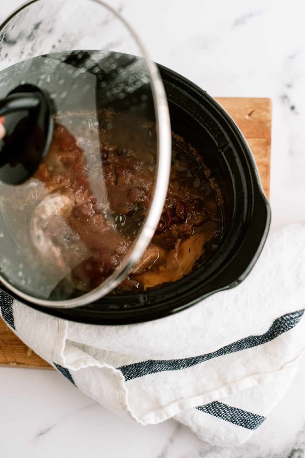 Slow Cooker Cranberry Pork Loin cooked in Slow Cooker with the lid on top