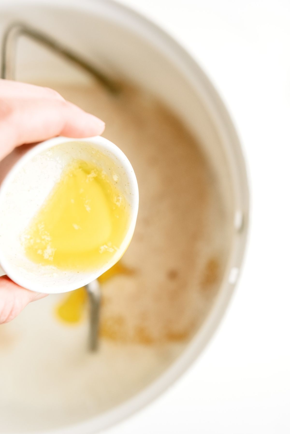 Melted butter poured into mixing bowl with other ingredients