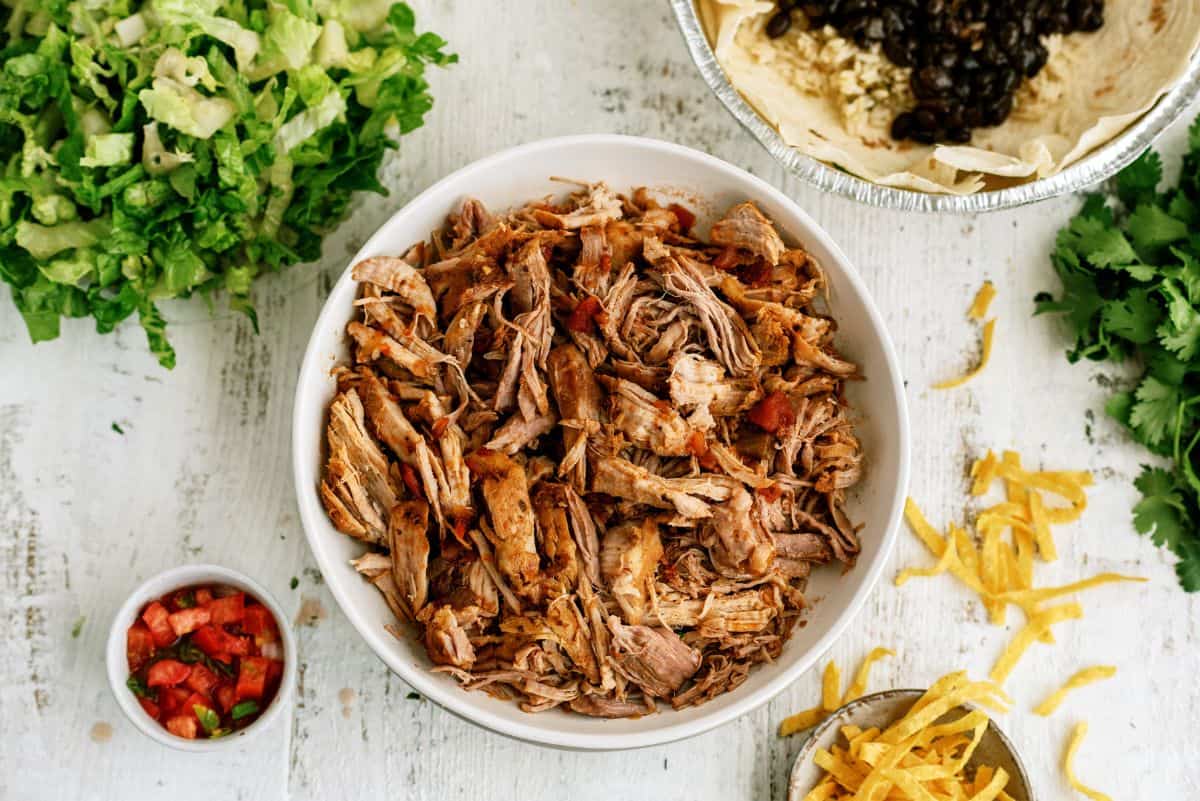 Cafe Rio Sweet Pork in a bowl surrounded by toppings