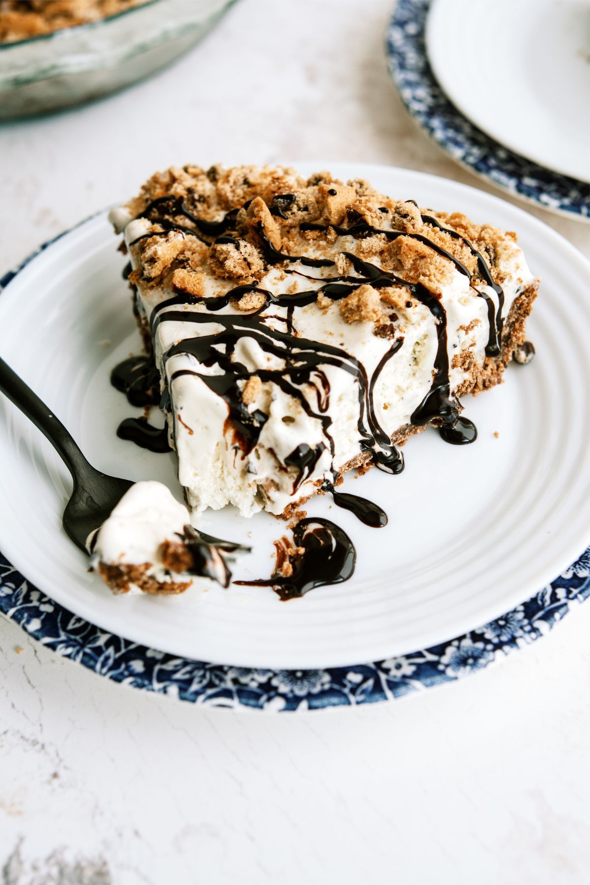 Piece of Chocolate Chip Cookie Ice Cream Pie on a plate with a fork