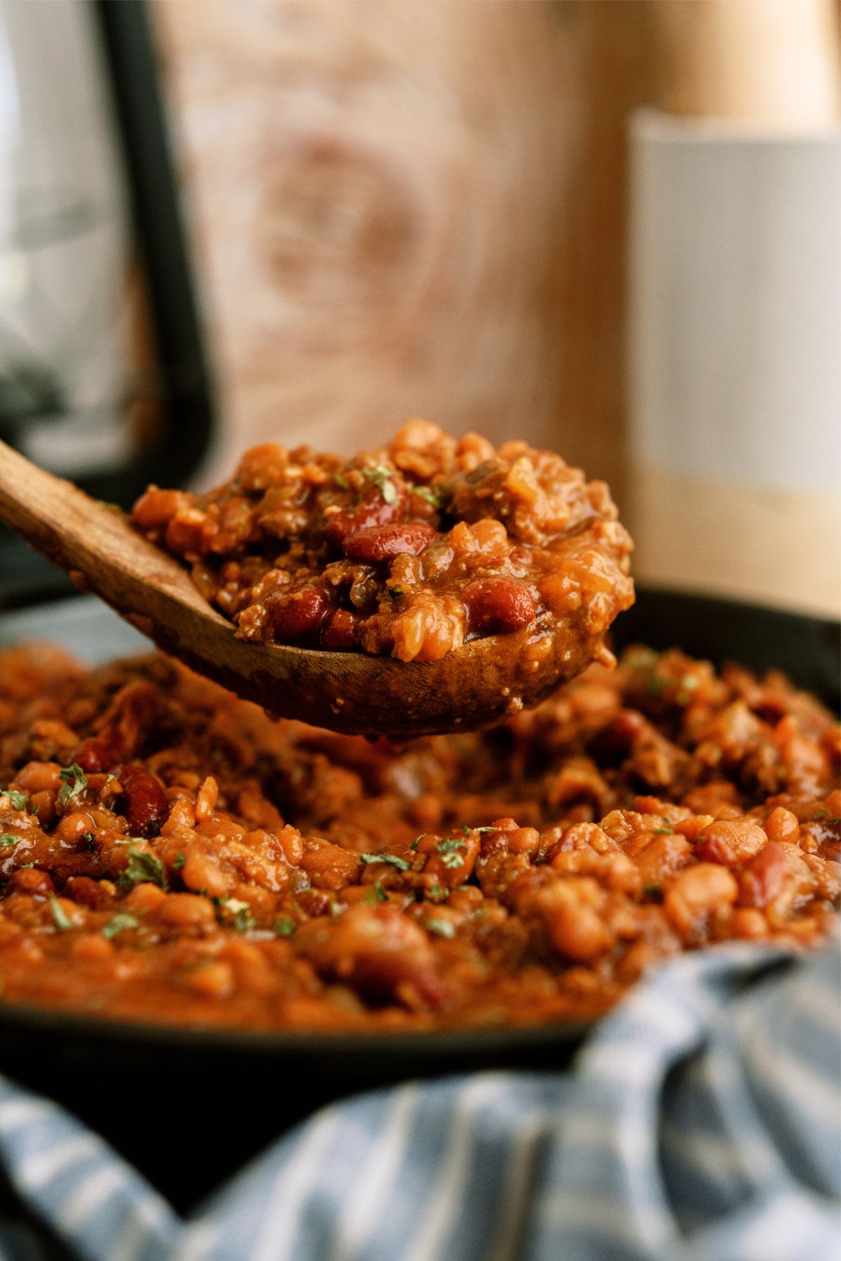 Cowboy Baked Beans with a spoonful being lifted from the pan