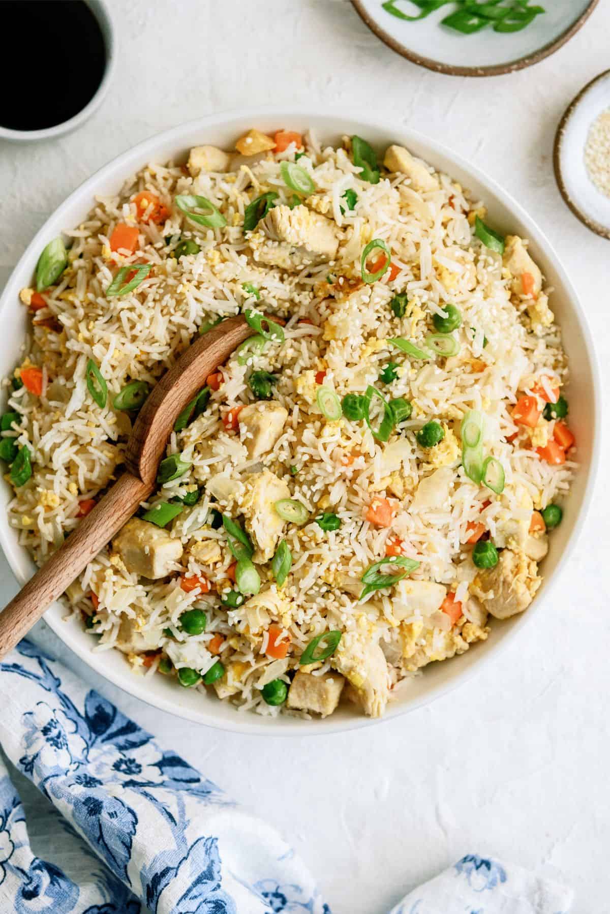 Instant Pot Chicken Fried Rice in a bowl with a wooden spoon