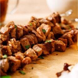 A skewer of Korean BBQ Beef on parchment paper.