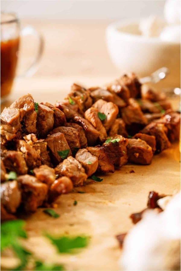 A skewer of Korean BBQ Beef on parchment paper.