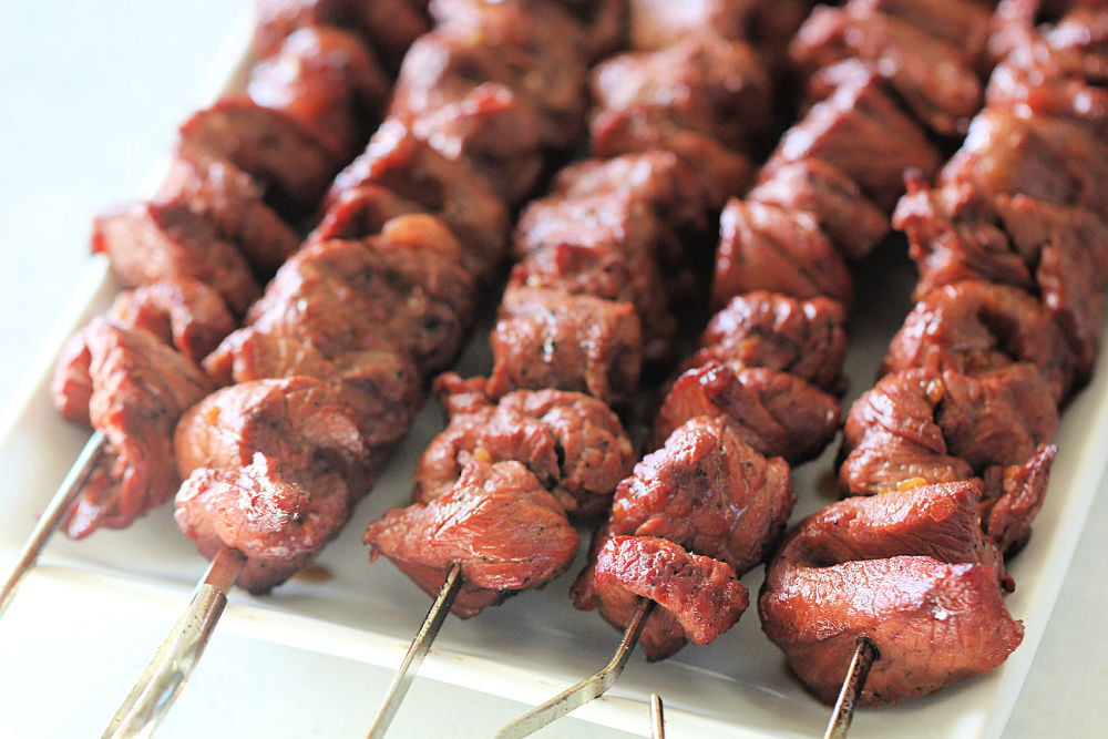 Korean BBQ Beef on skewers placed on a serving plate