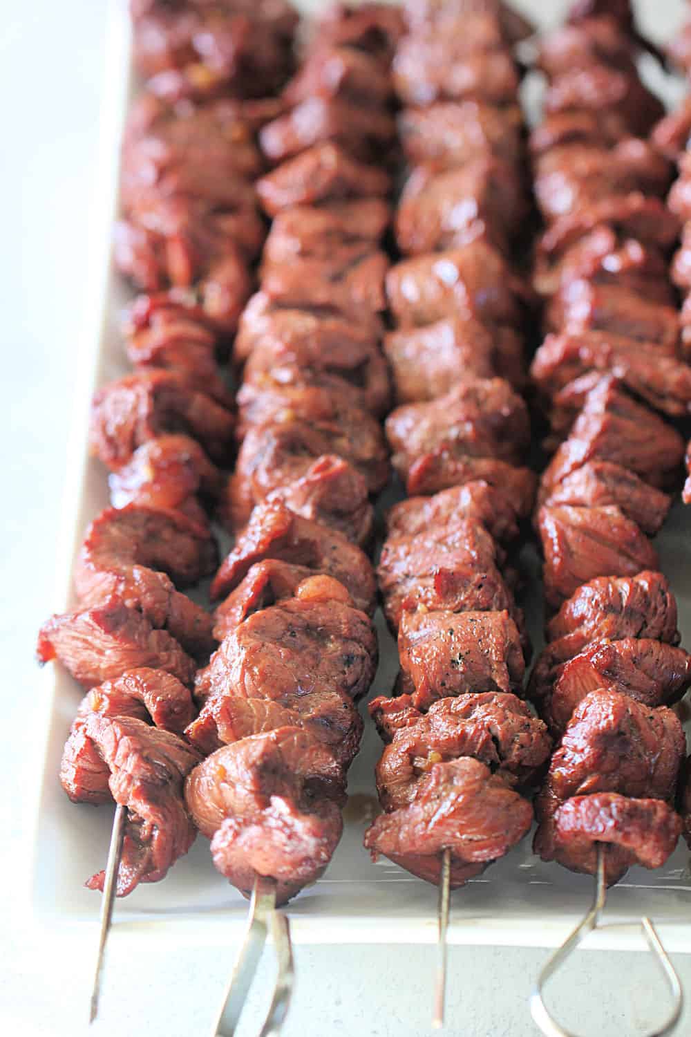 Korean BBQ Beef on skewers on a serving plate