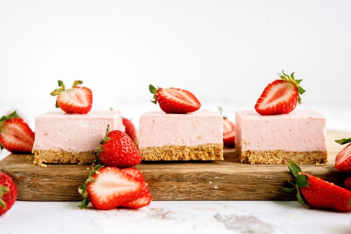 Side view of No Bake Strawberry Cheesecake Bars cut into squares