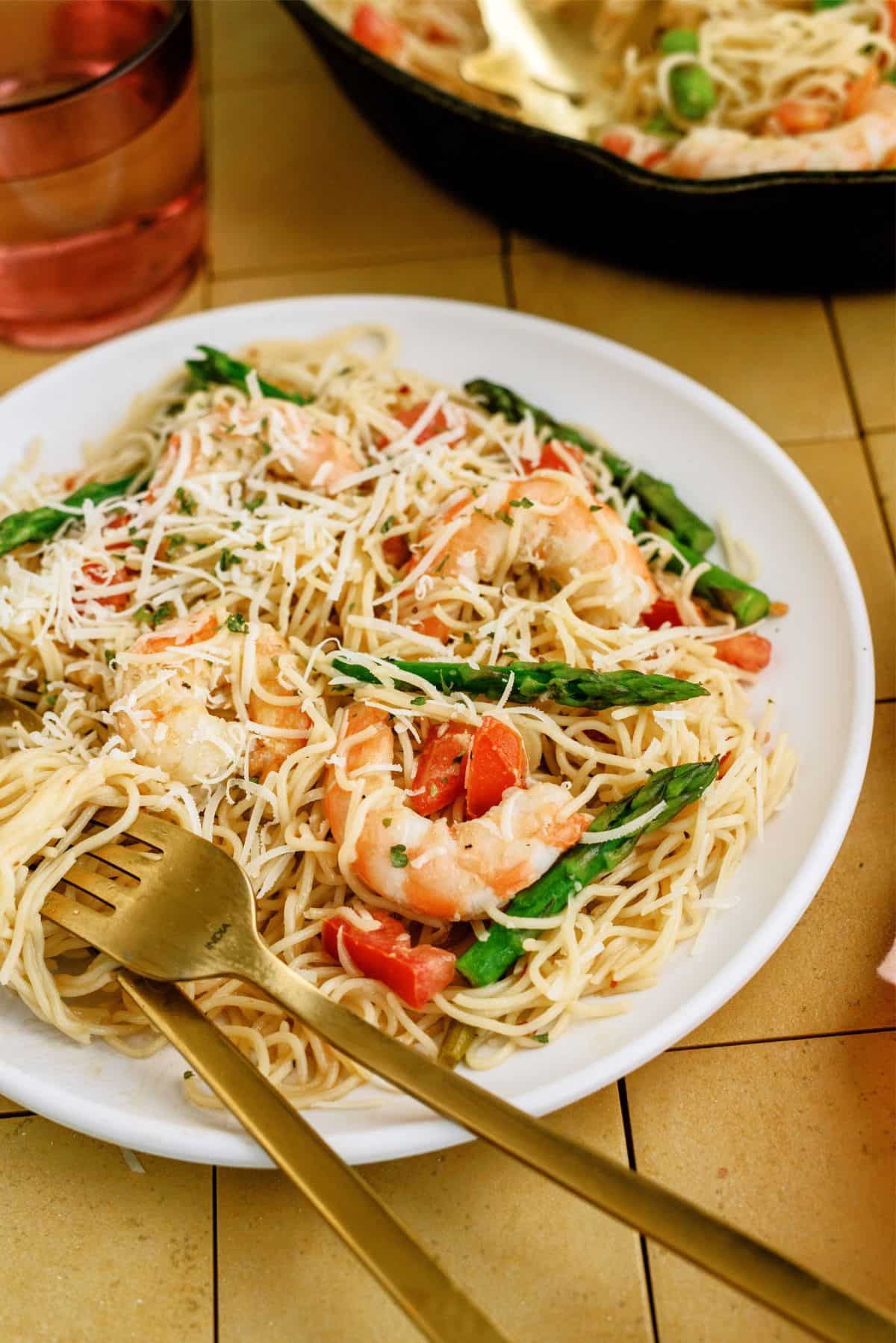 Side view of Olive Garden Shrimp Scampi Copycat Recipe on a plate with utensils