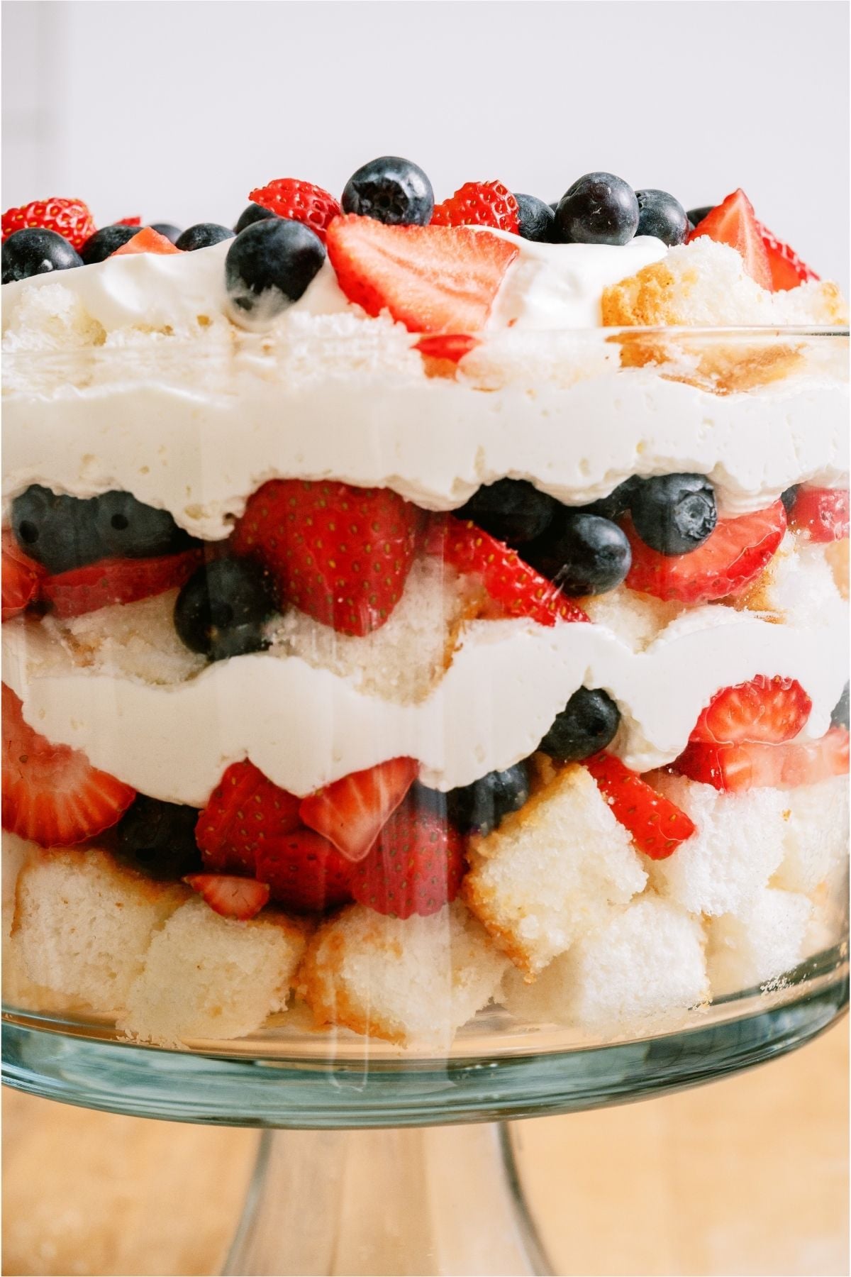 Side view of the layers of Patriotic Berry Trifle in a trifle dish.