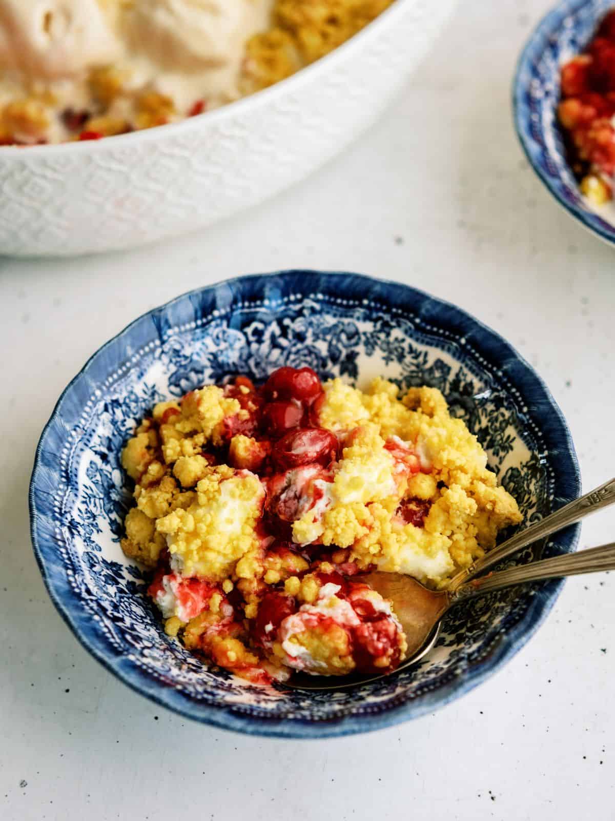 Scoop of  Cherry Cheesecake Dump Cake in a bowl