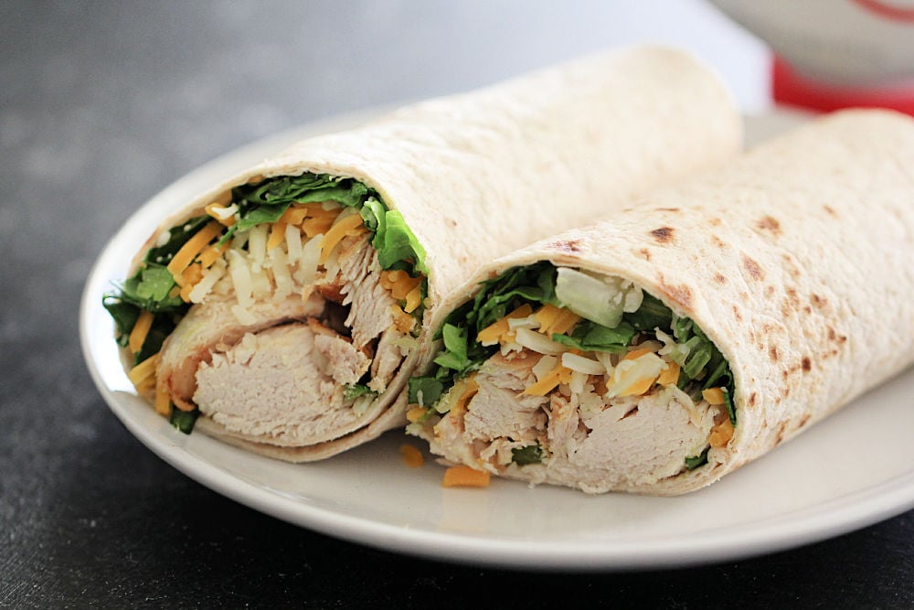 Copycat Chick-Fil-A Grilled Chicken Cool Wrap on a plate sliced in half