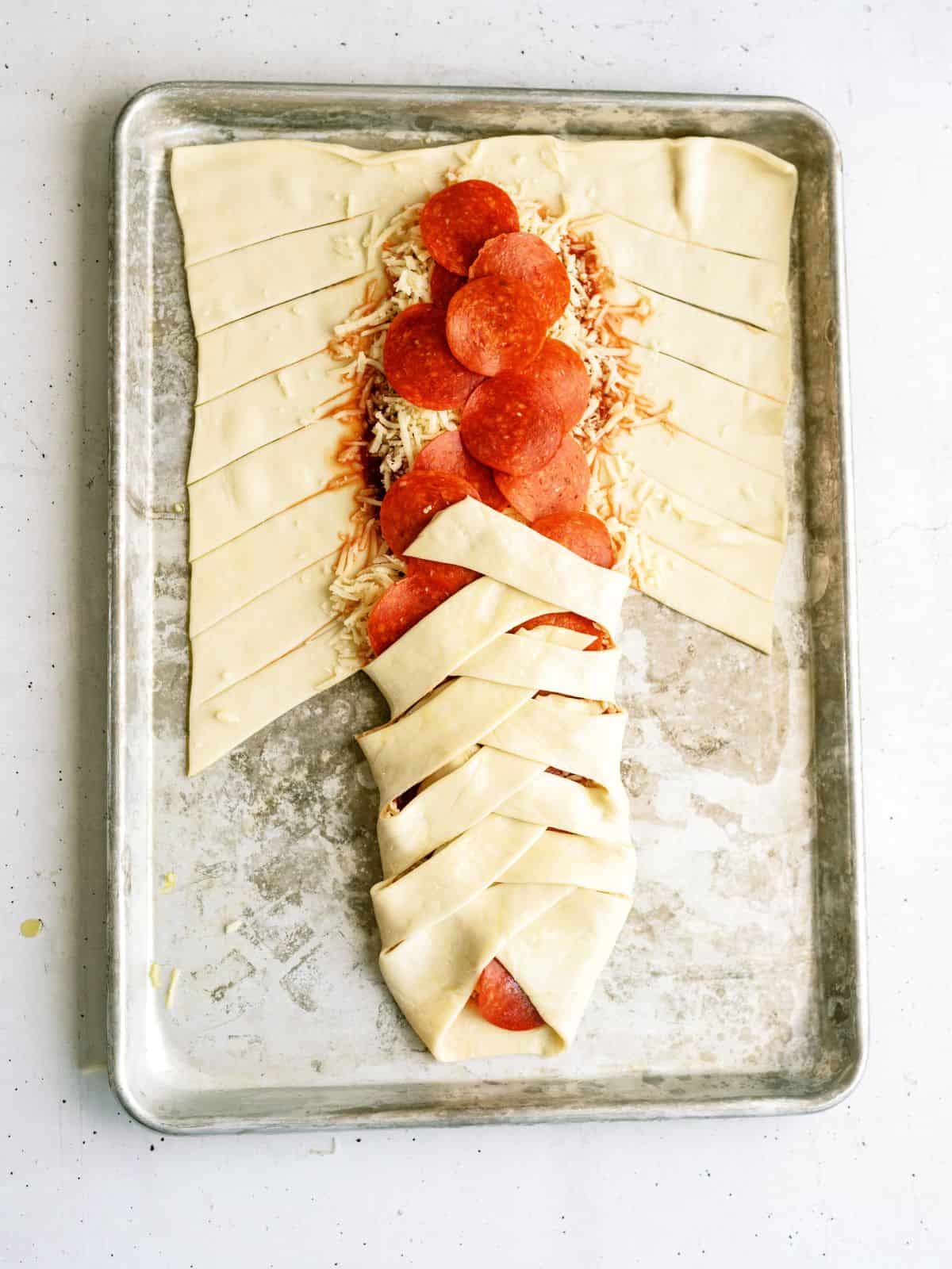 Pizza dough braided over the toppings in the center