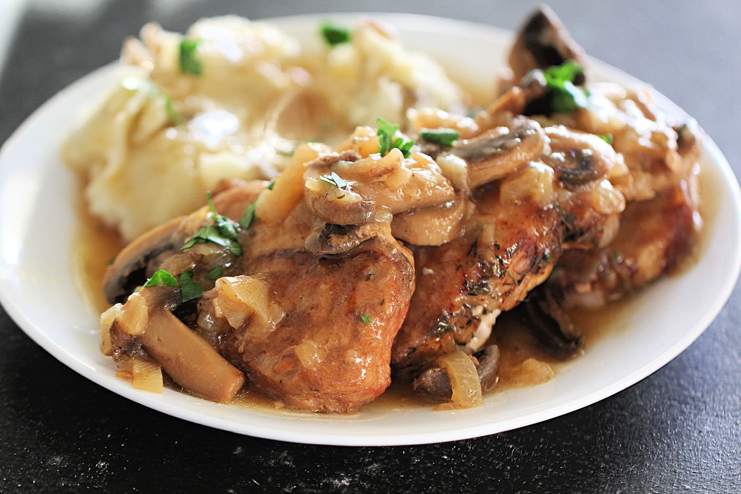 Instant Pot French Onion Pork Chops with gravy on a plate