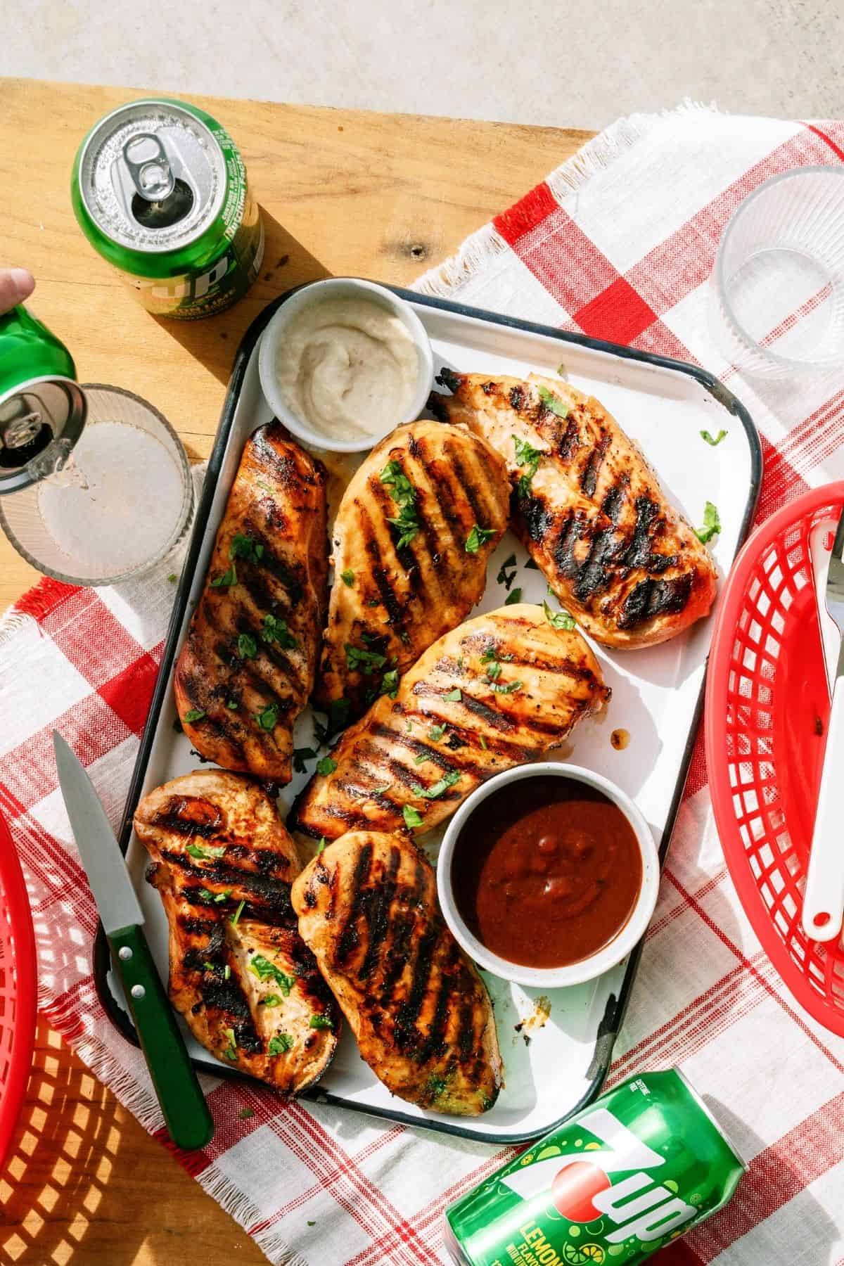 Mom's Grilled 7up Chicken on a platter with sauce.