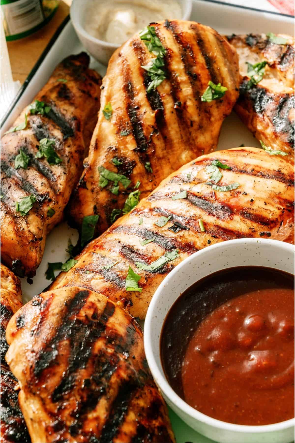 Close up of Mom's Grilled 7up Chicken with sauce in a cup.