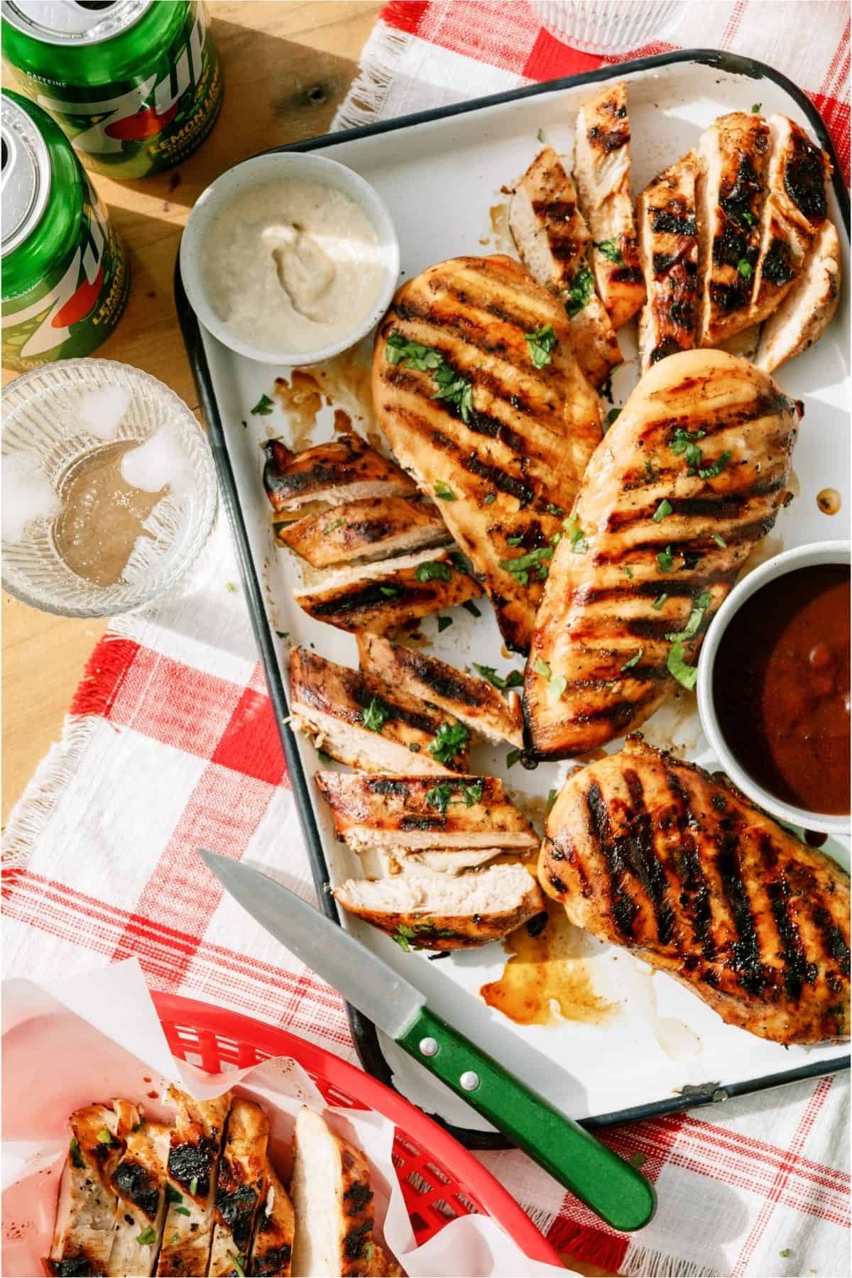 Top view of Mom's Grilled 7up Chicken on a platter with some chicken sliced.
