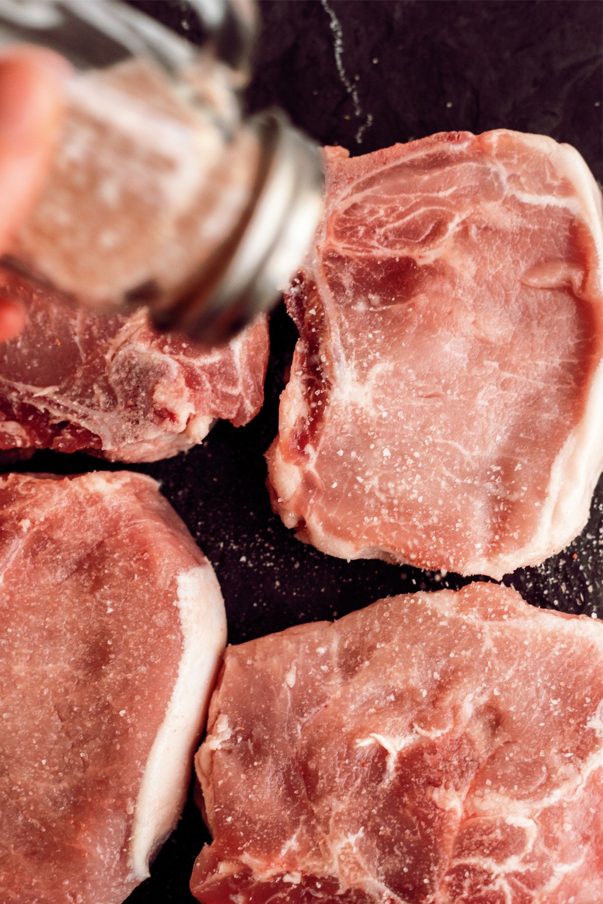 Salting raw pork chops
