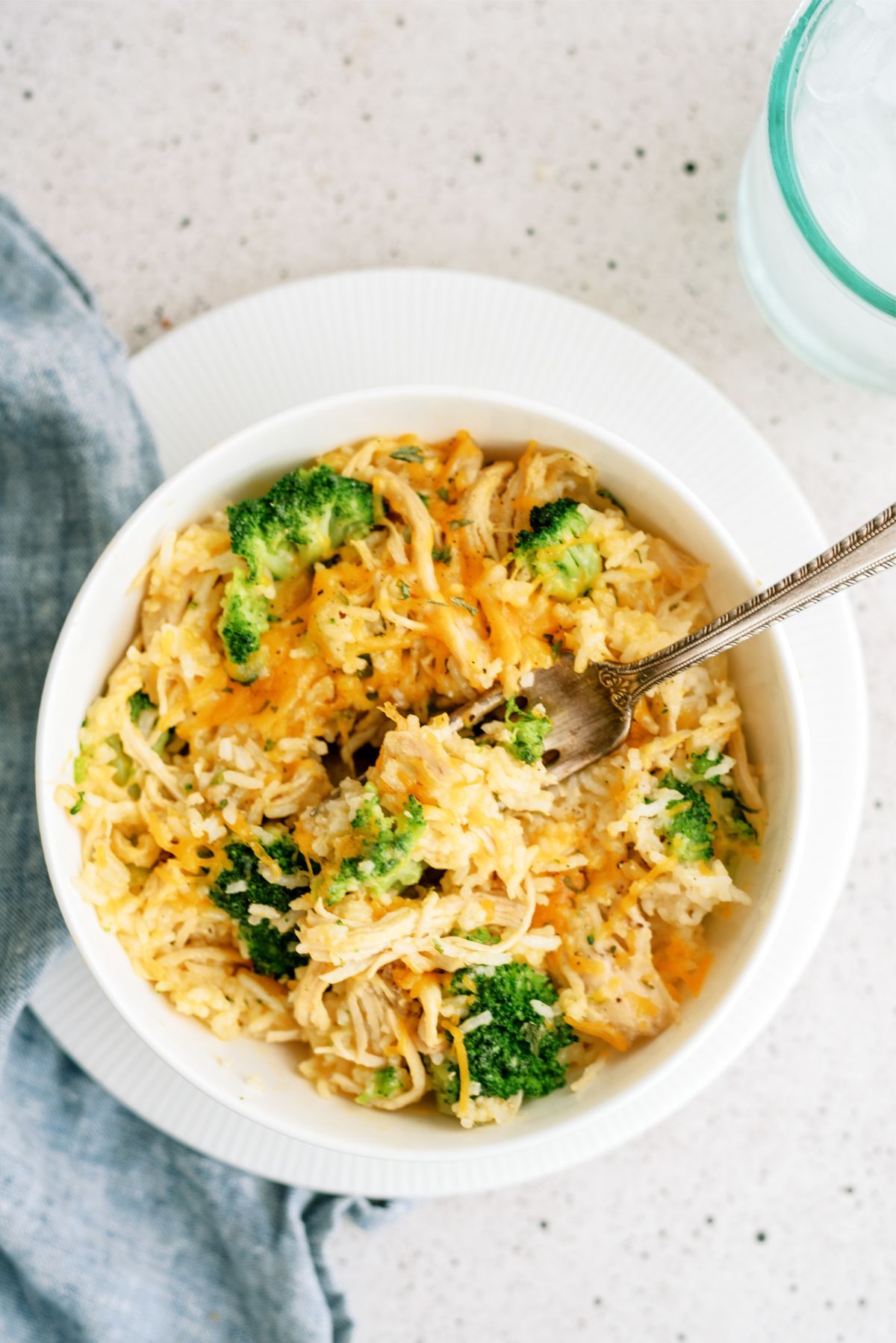 Instant Pot Cheesy Broccoli Chicken and Rice in a bowl with a fork