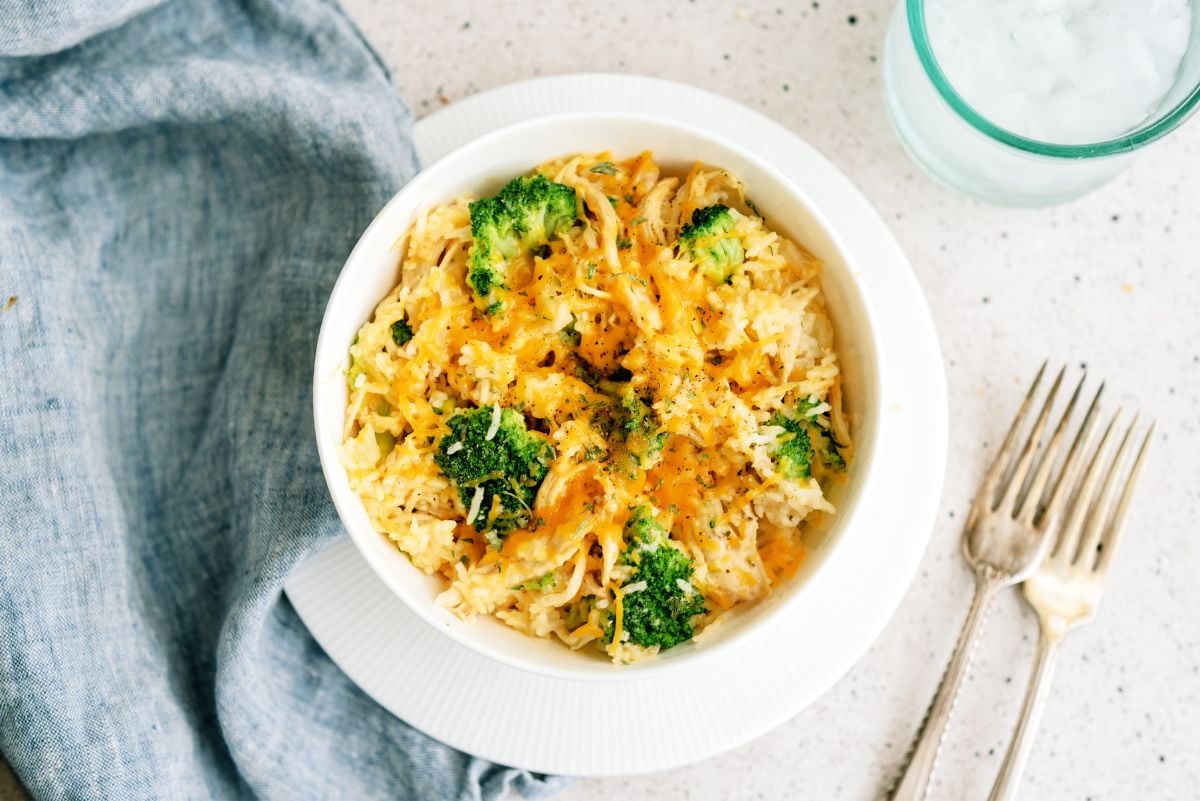 Top view of Instant Pot Cheesy Broccoli Chicken and Rice in a bowl with forks on the side