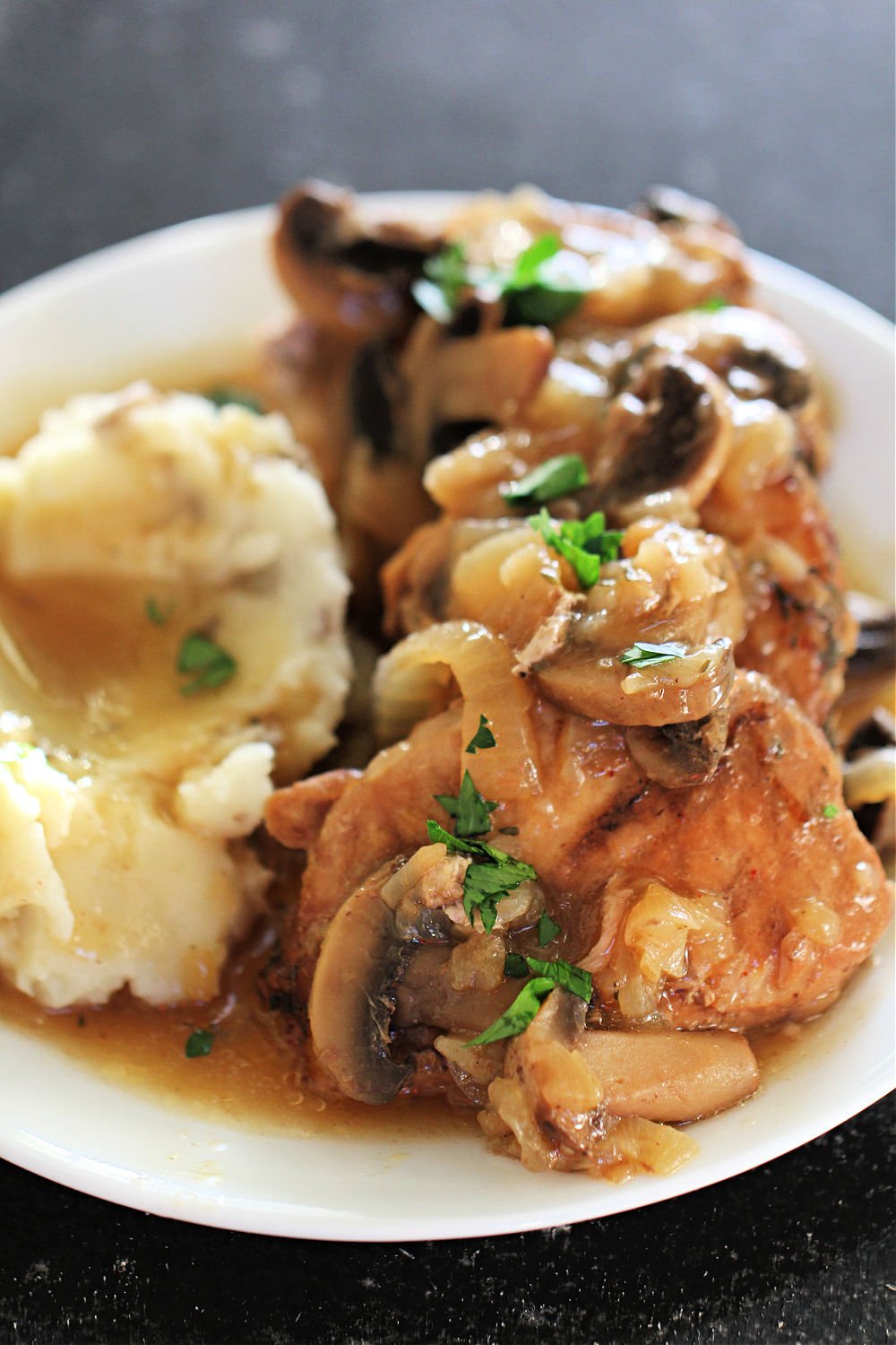 Instant Pot French Onion Pork Chops with gravy on a plate