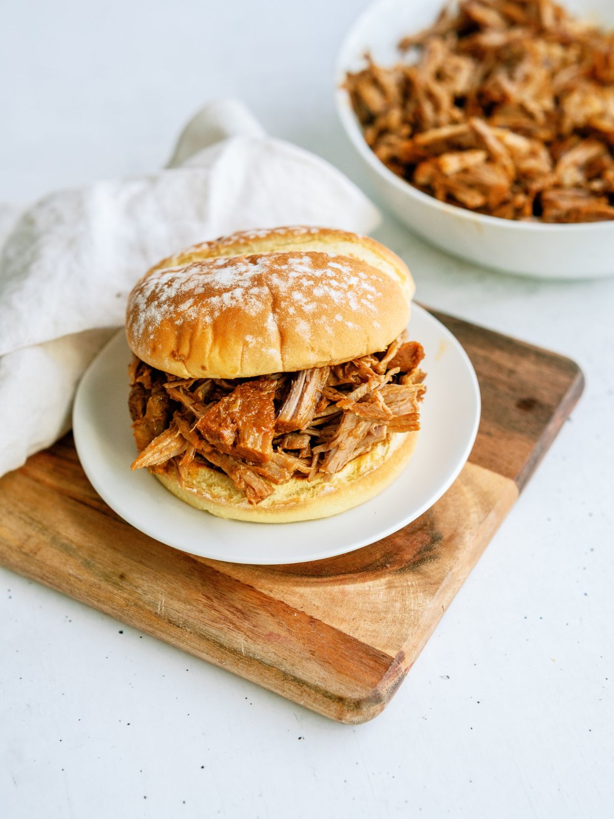Instant Pot Sweet and Sticky Pulled Pork Sandwich on a plate
