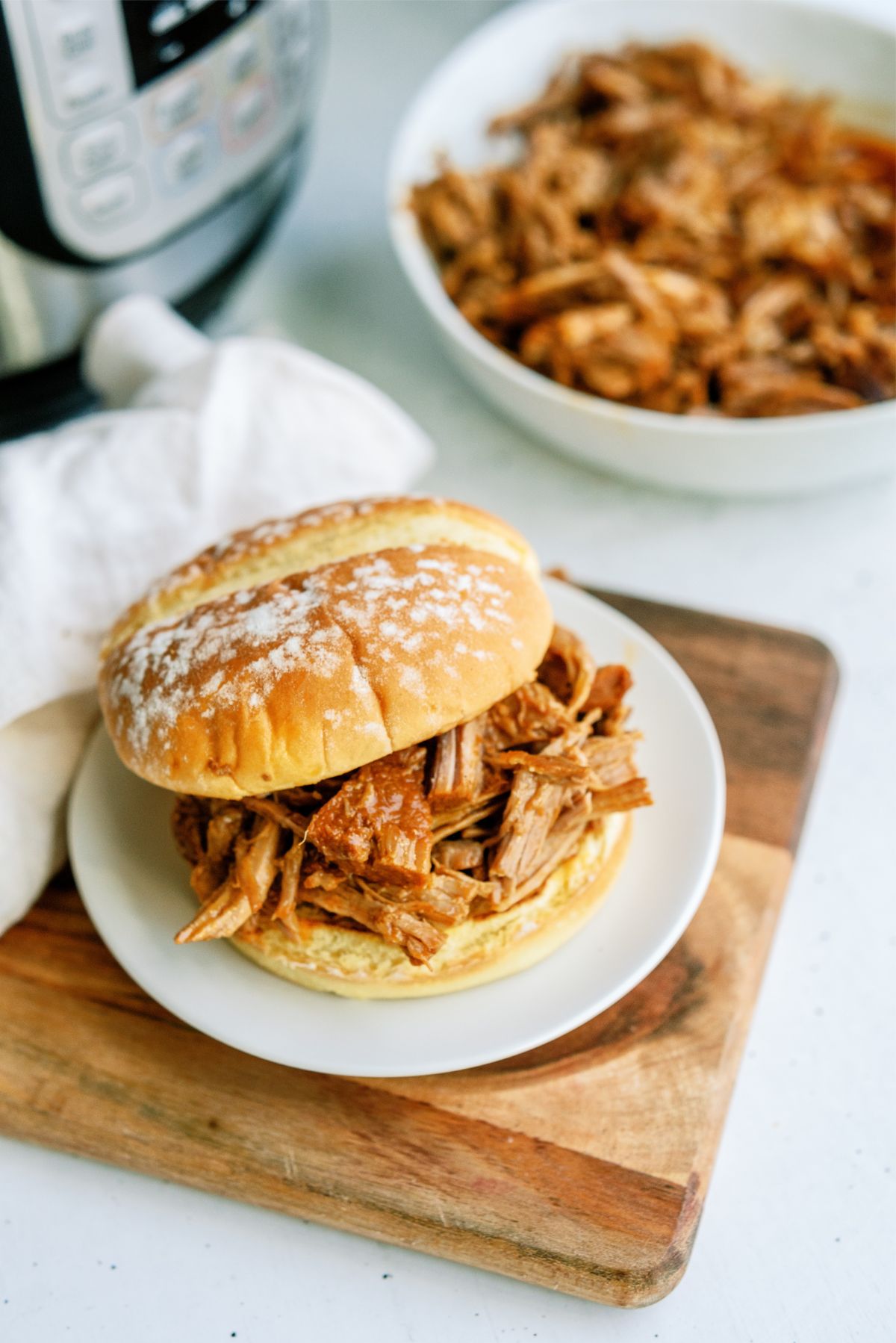 Instant Pot Sweet and Sticky Pulled Pork  Sandwich on a plate