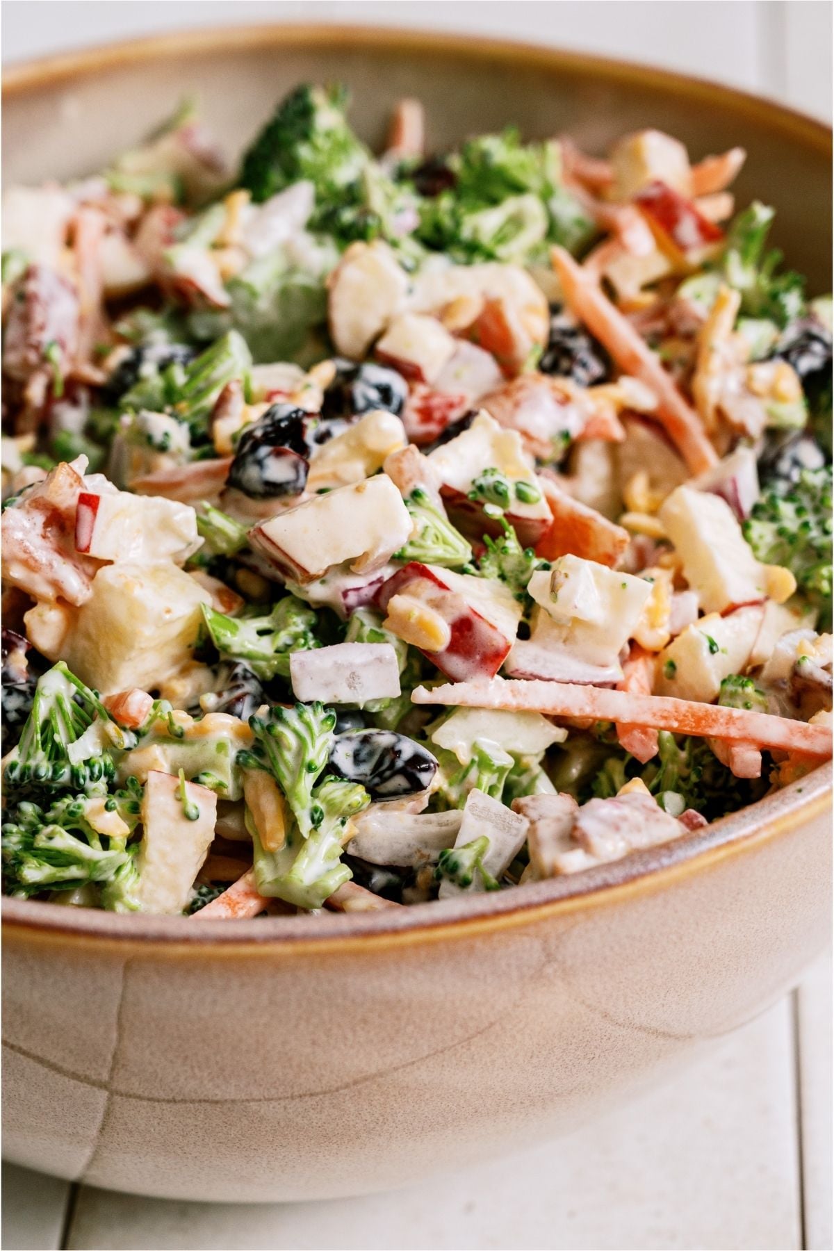 Side view of a serving bowl of Loaded Broccoli Salad.