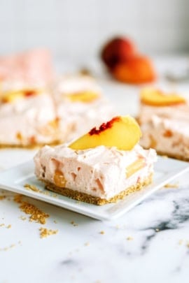 A square of No-Bake Peach Cheesecake Bars on a plate
