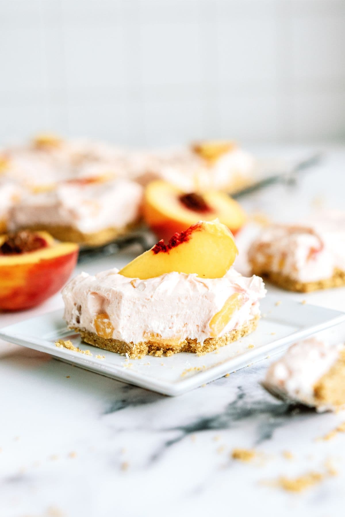 Slice of No-Bake Peach Cheesecake Bars on a plate