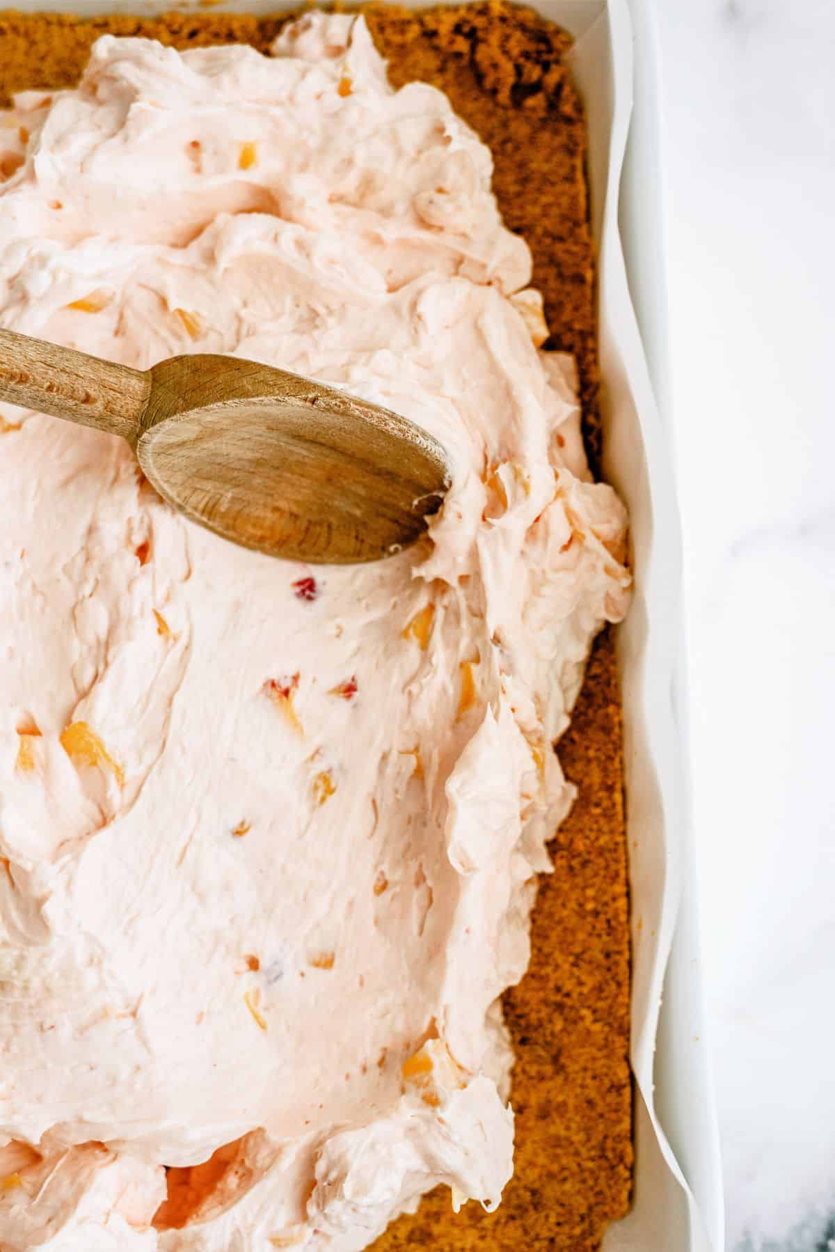 Spreading Jello mixture on top of graham cracker crust