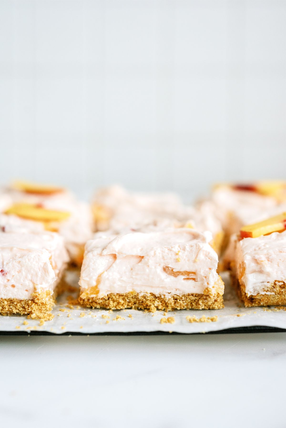 Side view of No-Bake Peach Cheesecake Bars cut into slices